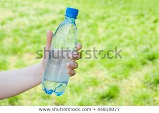 hand-offering-bottle-water-against-450w-44810077