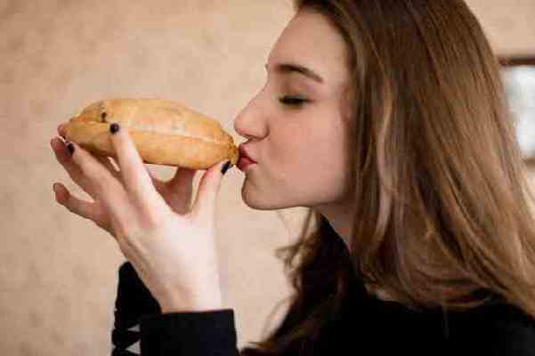 Person-kissing-a-pasty-from-Lawrys-Pasties-in-Michigan